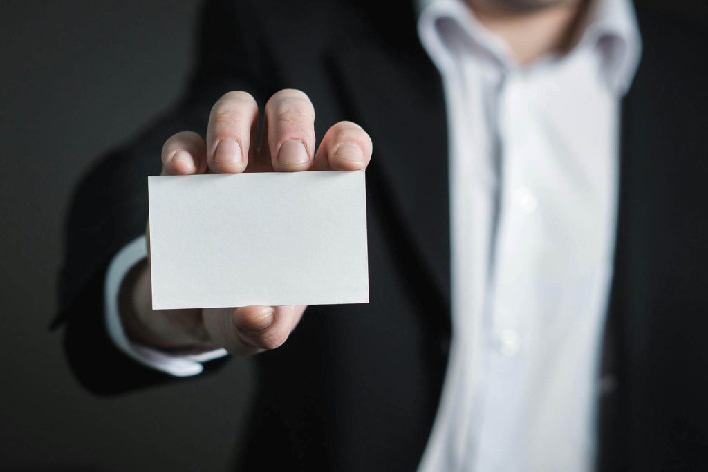 man holding a visitng card